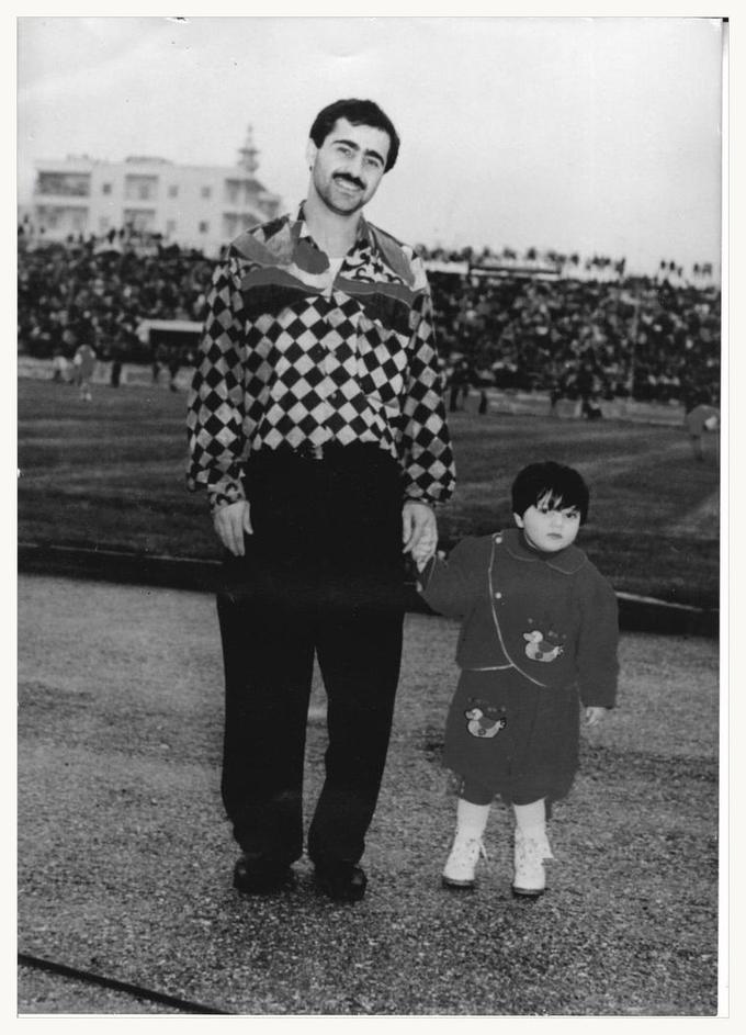 Houssam as a young child, holding his father's hand